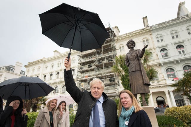 Boris Johnson joins Plymouth parliamentary candidate Rebecca Smith at the statue whilst on the campaign trail (Stefan Rousseau/PA)