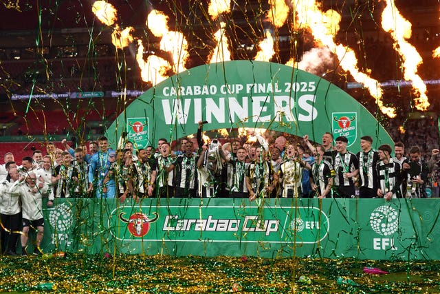 Newcastle’s Bruno Guimaraes and Kieran Trippier lift the Carabao Cup with their team-mates following victory over Liverpool at Wembley