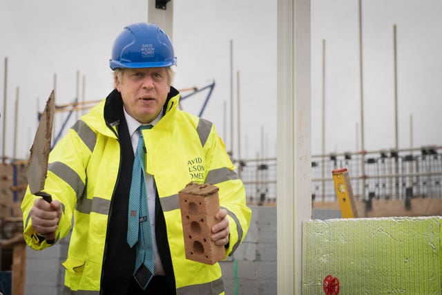 Boris Johnson tries his hand at bricklaying, at David Wilson Homes in Bedford