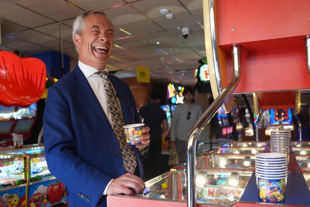 Reform UK leader Nigel Farage playing a 2p machine in Clacton-on-Sea, Essex