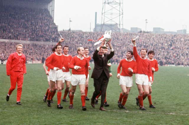 Charlton (fifth from left), Denis Law (far left) and George Best (far right) are among the players celebrating as United boss Busby holds the First Division title aloft in 1967 (PA).