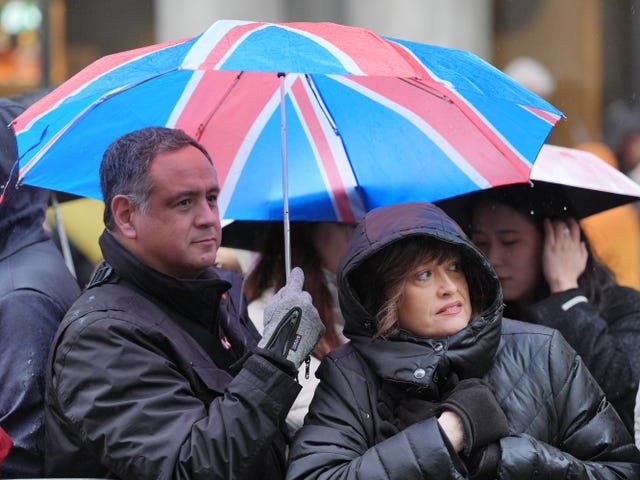 Rain falls as people gather to watch the New Year’s Day Parade in central London. 