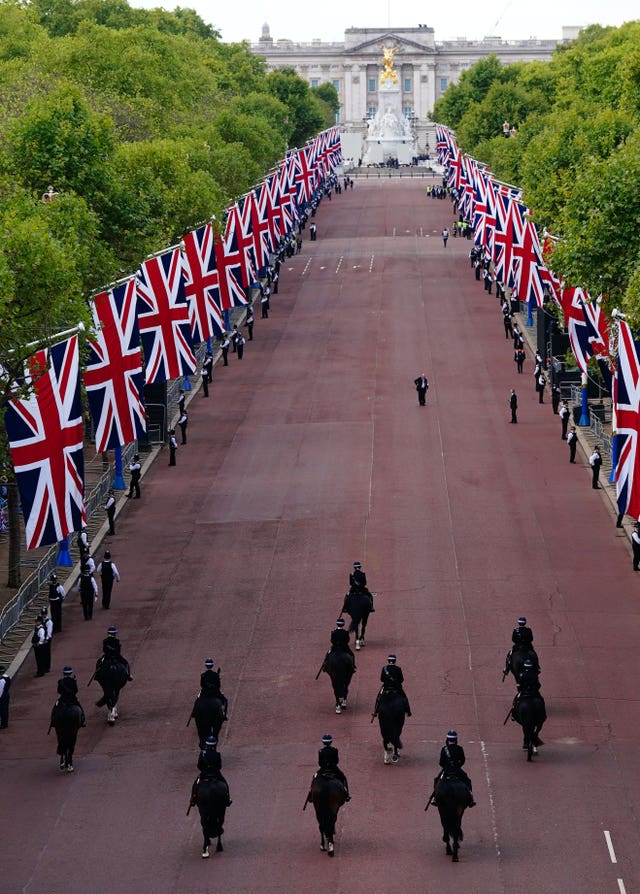 Mounted police pass along The Mall ahead of the ceremonial procession of the coffin of Queen Elizabeth II from Buckingham Palace to Westminster Hall 