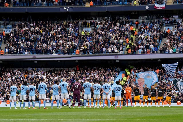 Players from Manchester City and Leeds stood in the centre circle for the national anthem