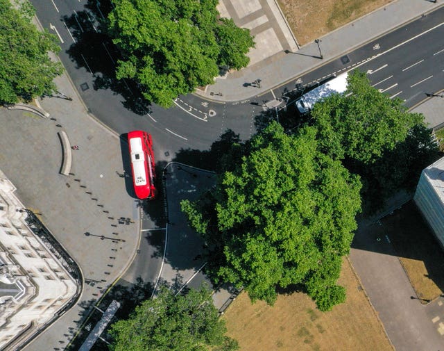 An aerial view of London showing a bus passing in front of the Supreme Court (bottom left) from Broad Sanctuary onto Parliament Square