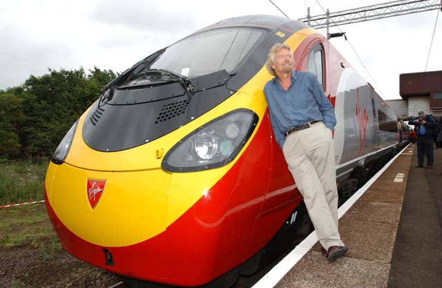 Virgin boss Sir Richard Branson stands next to Virgin Trains' new Pendolino train