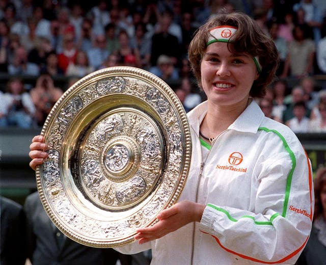 Martina Hingis poses with the Wimbledon trophy