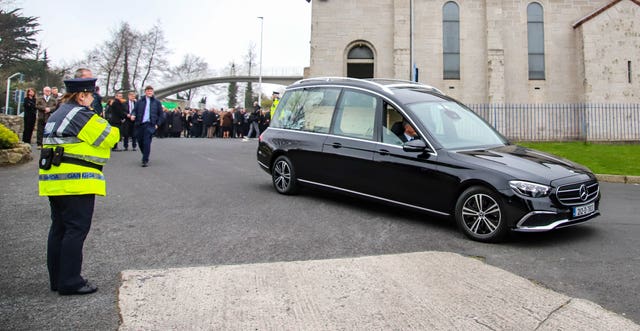 The hearse departs after the funeral 