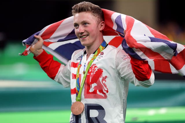 Gymnast Nile Wilson with his bronze medal at the Rio Olympics in 2016, draped in a Union Flag