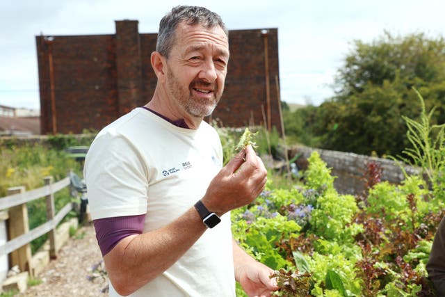 Chris Boardman picking lettuce in Lewes Football Club’s own garden