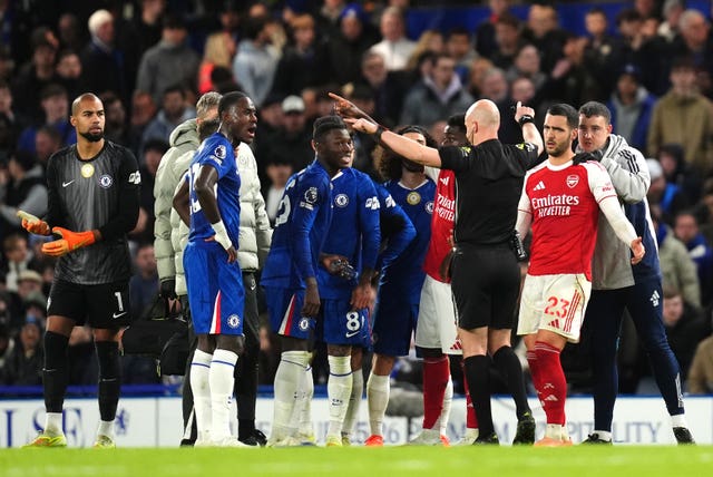Referee Anthony Taylor signals for a VAR check for a challenge by Chelsea’s Moises Caicedo on Arsenal’s Mikel Merino which resulted in a red card 
