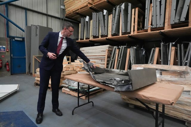 A man in a room with files of evidence