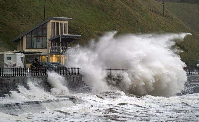 Waves crash over the promenade in Scarborough 