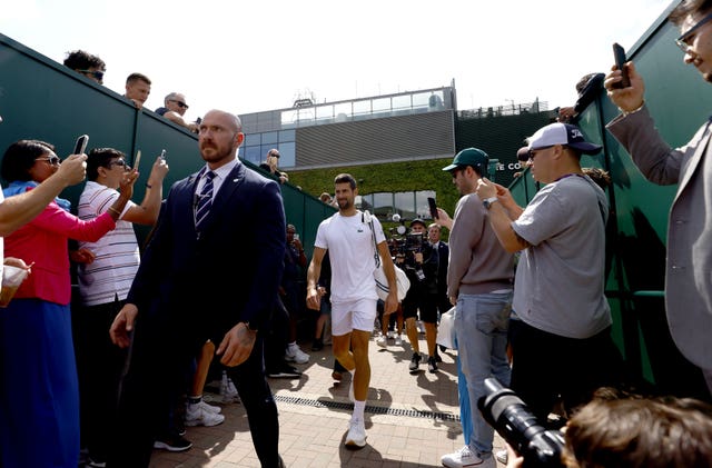 Novak Djokovic walking to a practice session