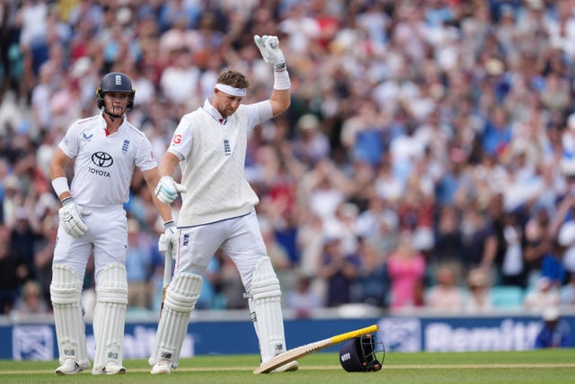 England’s Joe Root points to the sky while wearing a white headband in tribute to Graham Thorpe after reaching his century against India at the Oval