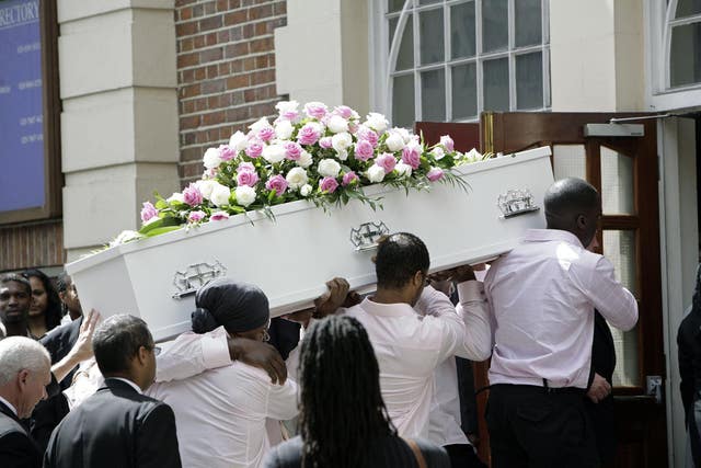 The coffin is carried from the hearse at the funeral of murdered young QPR footballer Kiyan Prince 