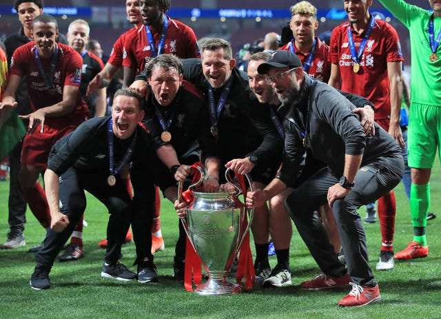 Jurgen Klopp, right, and his staff celebrate with the trophy after the 2019 Champions League final