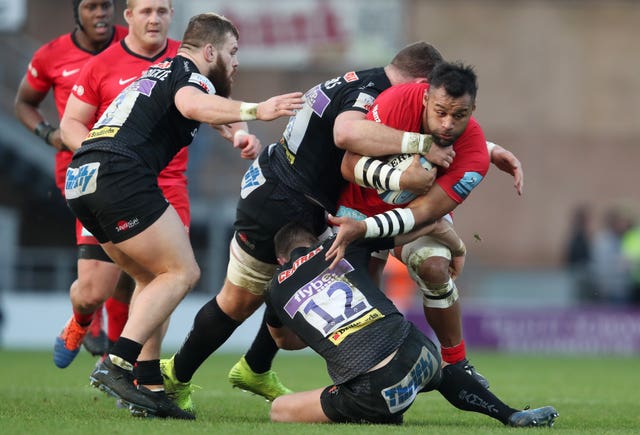 Saracens’ Billy Vunipola is tackled by Exeter’s Dave Ewers and Ollie Devoto