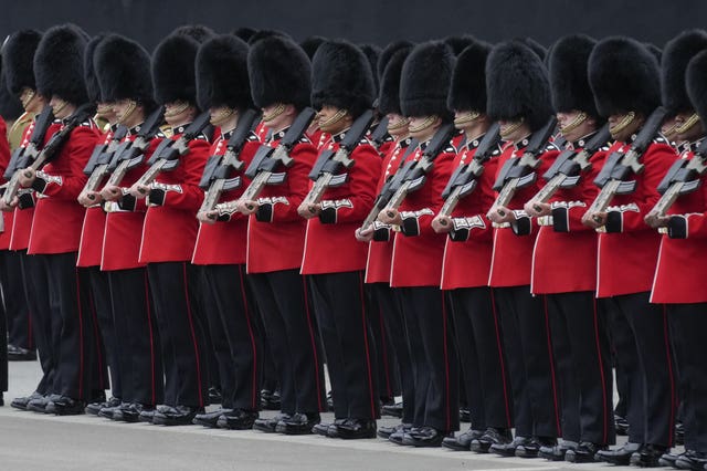 The Queen’s Guard line up at the Palace of Westminster in London, ahead of the State Opening of Parliament in the House of Lords, London