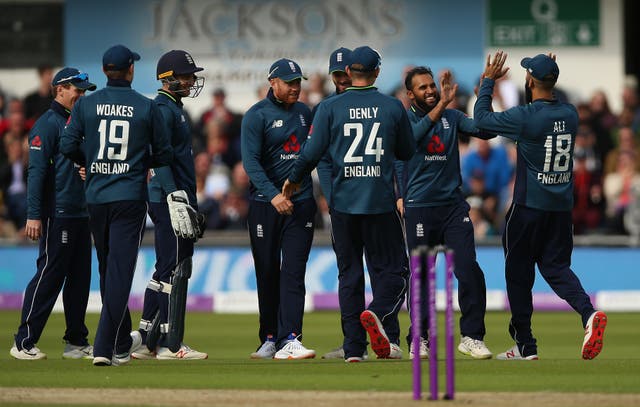Adil Rashid, second right, is congratulated after his brilliant return catch removed Shoaib Malik