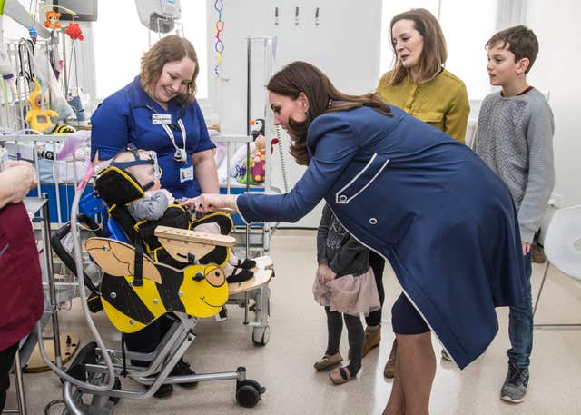 The Duchess of Cambridge meets 10-month-old Amara Kedwell- Parsons who was born prematurely and is a patient at St Thomas’ Hospital, London, (Richard Pohle/The Times/PA)