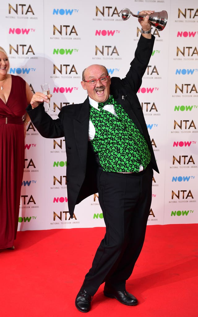 Brendan O'Caroll holding NTA trophy