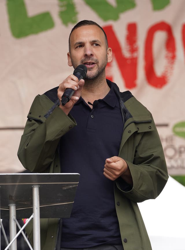 Zack Polanski speaking into a microphone