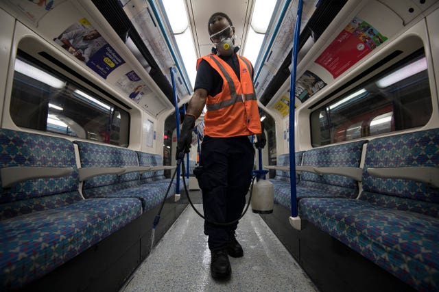 A TfL worker deep cleans a Victoria Line Tube train 