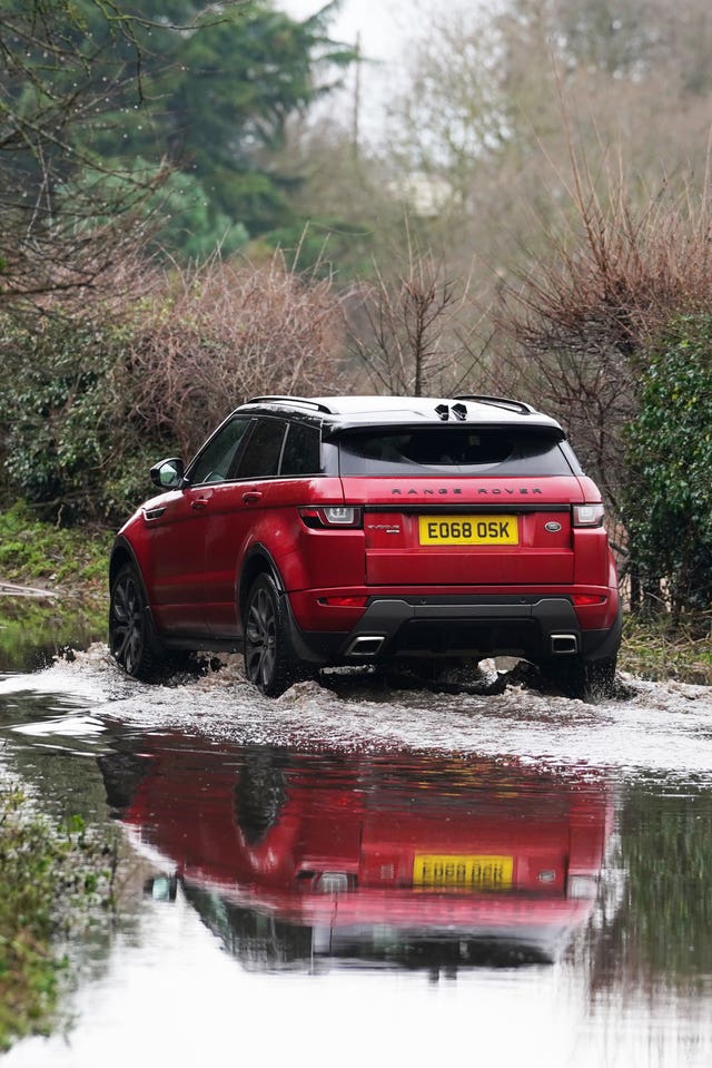 A car drives through floodwater near Swanley in Kent