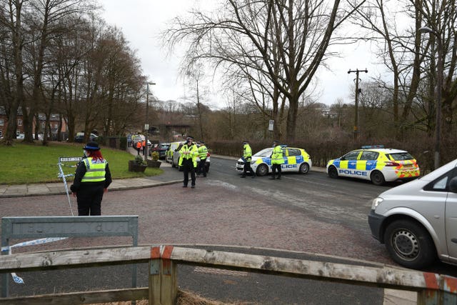 Officers patrol a police cordon in Ramsbottom, Bury, Greater Manchester, where the body of a woman has been found after a house collapsed on Wednesday evening