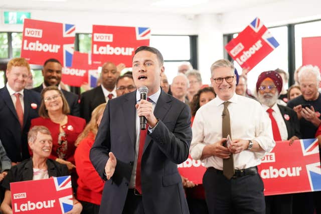 Sir Keir Starmer looks on as Wes Streeting gives a speech on the General Election campaign trail