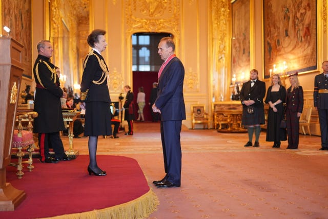 Alistair Phillips-Davies being made a CBE by the Princess Royal