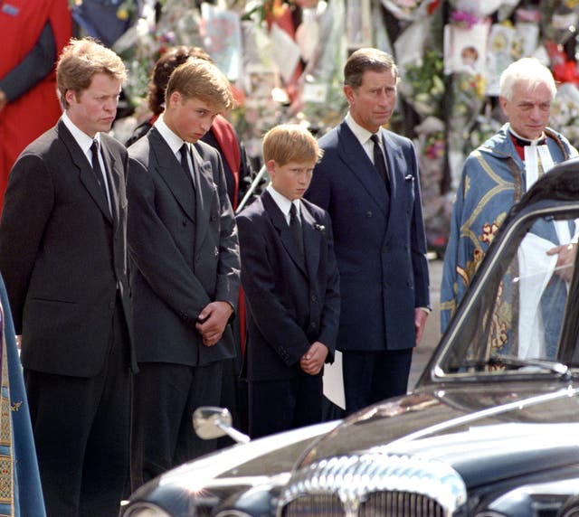 Earl Spencer, Prince William, Prince Harry, and the-then Prince of Wales watch Diana's hearse depart after her funeral in 1997 