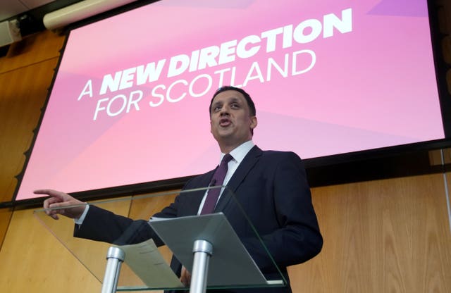 Anas Sarwar pointing while speaking from a lectern