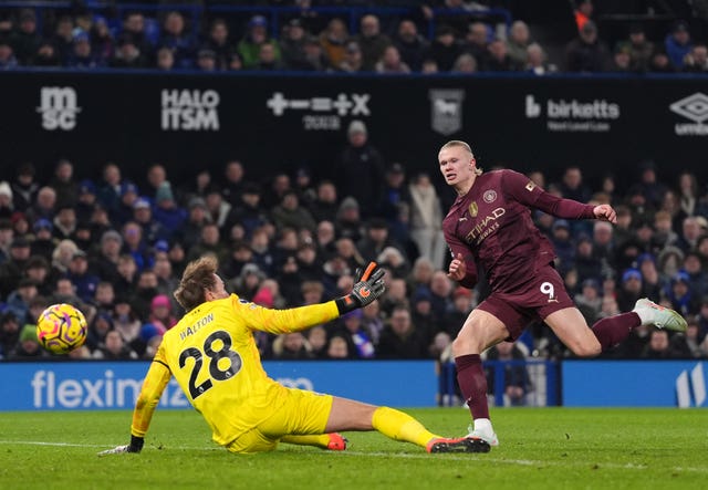 Erling Haaland clips the ball past Christian Walton for Manchester City's fifth goal against Ipswich