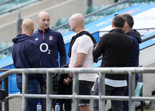 England head coach Steve Borthwick stands with a group of others during a training session at Twickenham