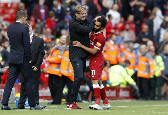 Jurgen Klopp (left) feels Salah committing to Liverpool 