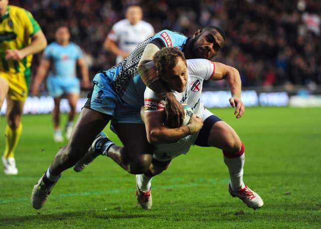 Rob Burrow scores a try for England under pressure from Fiji’s Marika Koroibete during the 2013 World Cup 