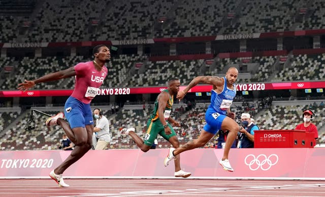 Italy's Lamont Jacobs (right) wins the men's 100 metres
