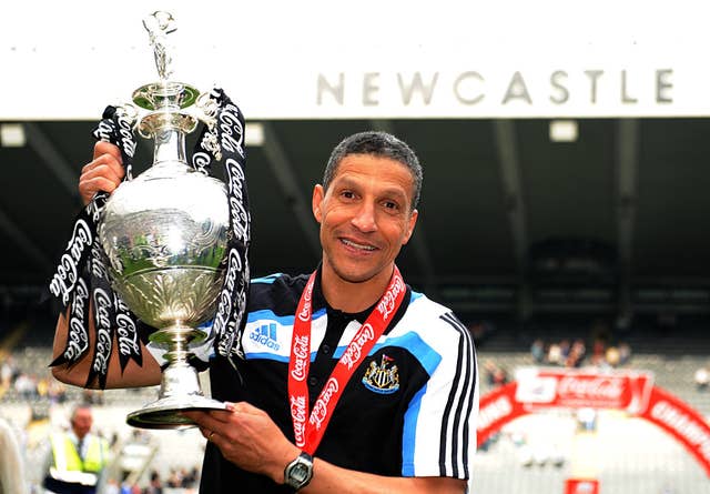 Newcastle manager Chris Hughton celebrates with the Championship trophy