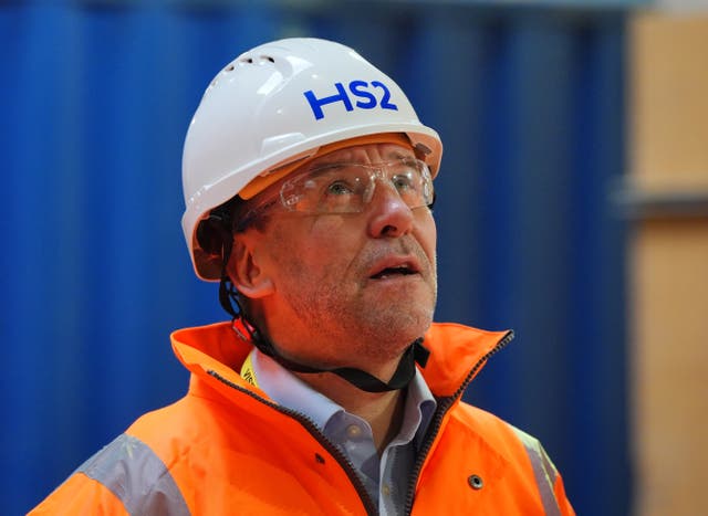 Mark Wild, in hi-vis jacket and HS2 hard hat, looks upwards during a tour of one of the project's sites