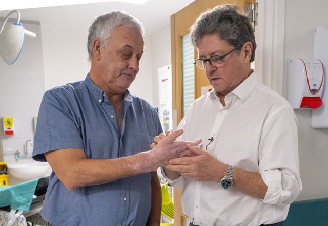 Mark Cahill's hand is examined by Simon Kay