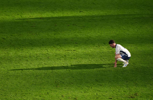 England midfielder Declan Rice crouches down on the pitch