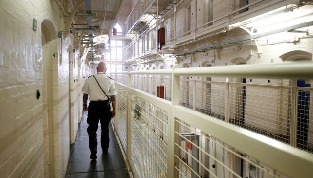 A prison guard walks through a prison