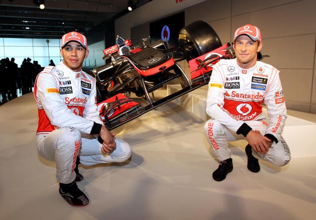 Lewis Hamilton (left) and Jenson Button (right) pose with a McLaren