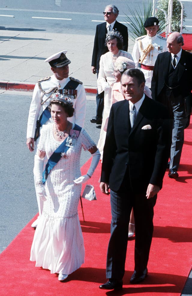 Queen Elizabeth II, accompanied by then-Australian Prime Minister Malcolm Fraser (followed by the Duke of Edinburgh) during her Silver Jubilee visit to Australia