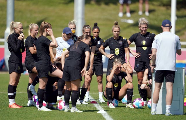 Sarina Wiegman, centre left, gives instructions to her England team in training