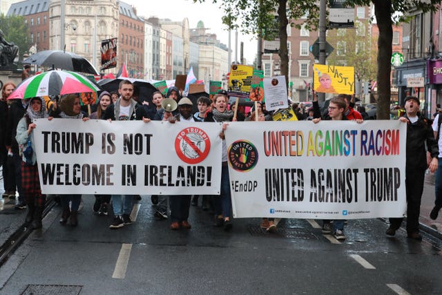 Anti-Trump demonstrators walk along O’Connell Street