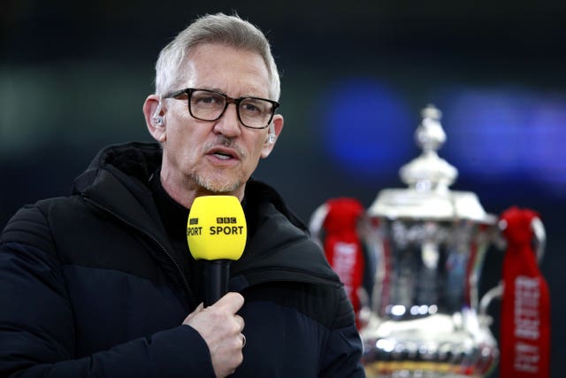 Gary Lineker presents FA Cup coverage for the BBC, with the trophy in the background