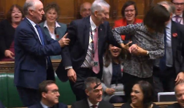 Sir Lindsay Hoyle (centre) is dragged to the speaker’s chair